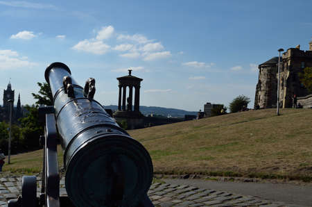 View of Nelson's Monument Park in Edinburgh, Scotland. There is a cannon pointing at the Dugald Stewart Monument.のeditorial素材