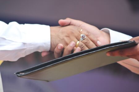 Two men are shaking hands.They agree with their viewpoint.So they shaking hand.の写真素材