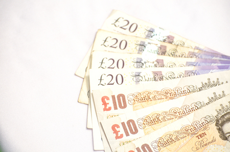 Ten and twenty pound British currency on white background