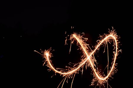 Sparkling fireworks in black background.の写真素材