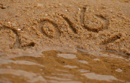 Bringing of Year 2016. The text 2015 and 2016 are written in sand.