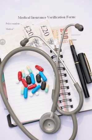 British currency for health insurance form fill-up.の写真素材