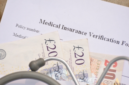 British currency for health insurance form fill-up.の写真素材
