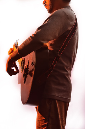 Boy playing music with acoustic guitar.の写真素材