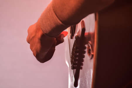 Close-up of boy playing music with acoustic guitar.の写真素材