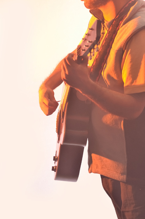 Close-up of boy playing music with acoustic guitar.の写真素材