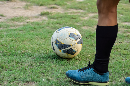 Boy is playing soccer in a ground.Boy is going to kick a soccer ballの写真素材