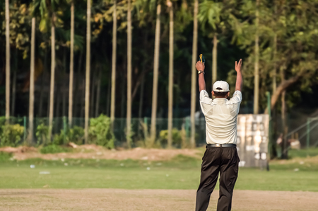 Boys are playing cricket on Maidan area at Calcutta, India. Maidan is a public place and anyone can capture photograph. There is no ticket, anyone can see. There is open ground, no stadium there no entry point.のeditorial素材