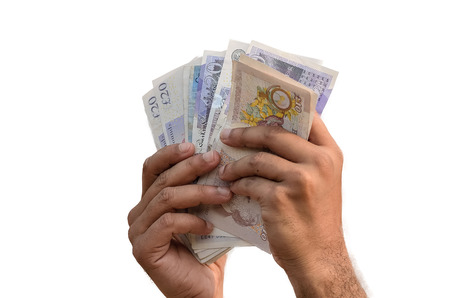 Man counting English Pound in white background.の写真素材
