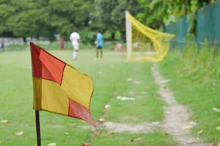 soccer field showing the corner post and flag and the goals in the background.の写真素材