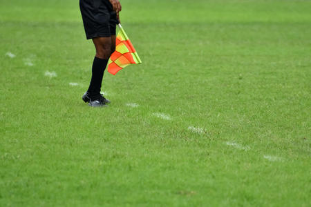 Assistant referee running along the sideline.の写真素材