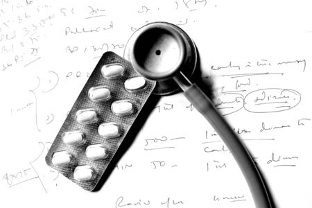 Stethoscope and pills on prescriptionの写真素材