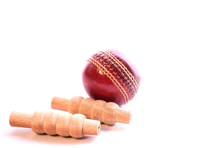 Cricket ball and bails on isolated white backgroundの写真素材