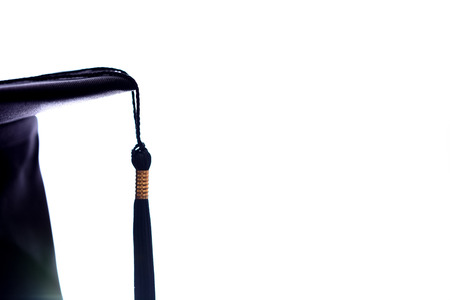 Young Man in a Graduation cap wear on isolated whiteの写真素材