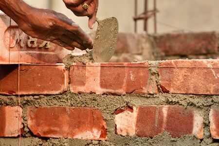 To build up a brick wall with trowelの写真素材