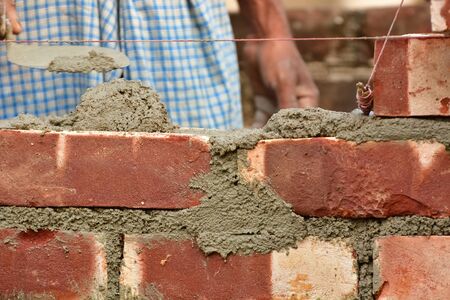 To build up a brick wall with trowelの写真素材
