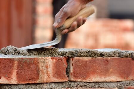 To build up a brick wall with trowelの写真素材