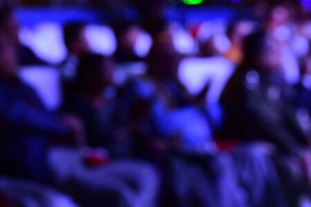 People are sitting in a conference. The photograph is taken as a blur.の写真素材