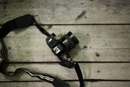 Analog film camera on wooden backgroundの写真素材