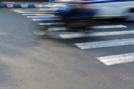 motor baike crossing zebra crossingの写真素材