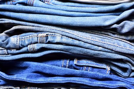 Stack of blue denim jeansの写真素材