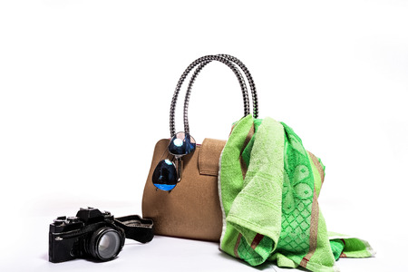 Travel accessories on white wooden background