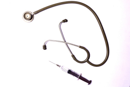 Stethoscope and injection syringe on white backgroundの写真素材
