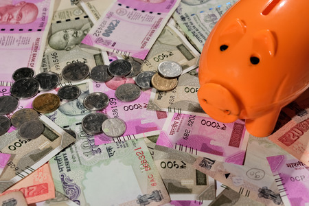 Saving Indian currency in Piggy bankの写真素材