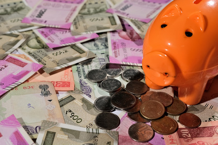 Saving Indian currency in Piggy bankの写真素材