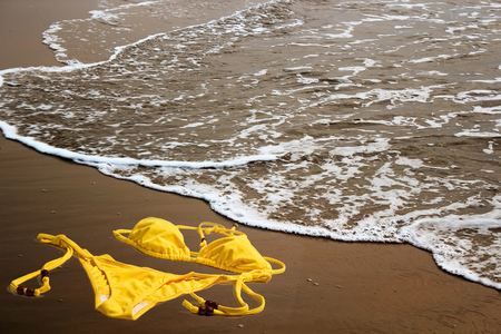 Bikini on empty beach sandの写真素材