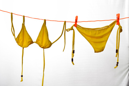 Bikini hanging on white backgroundの写真素材