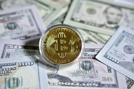 Bitcoin on dollars backgroundの写真素材