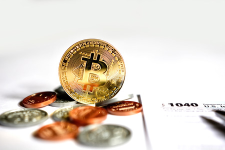 Close up of virtual currency bitcoin with US coins.の写真素材