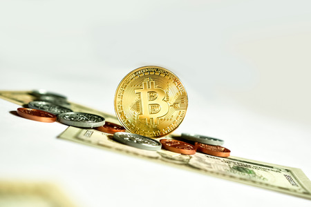 Close up of virtual currency bitcoin with US currency