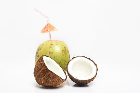 Broken coconut and green coconut isolated on white backgroundの写真素材