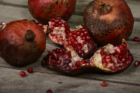Juicy pomegranate on wooden backgroundの写真素材