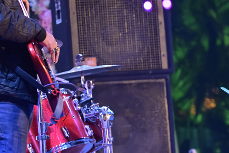 Close-up of guitarist playing guitar in live concert on stage.の写真素材