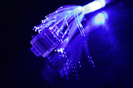 Network cable with fiber optics light on black background