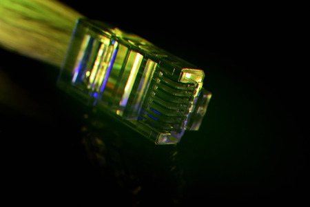 Network connection plug with fiber optics cable isolated on black background