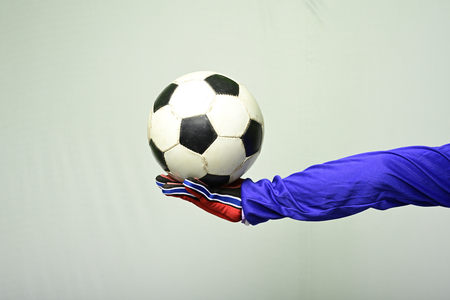 Soccer goalkeeper offer ball to play against white backgroundの写真素材