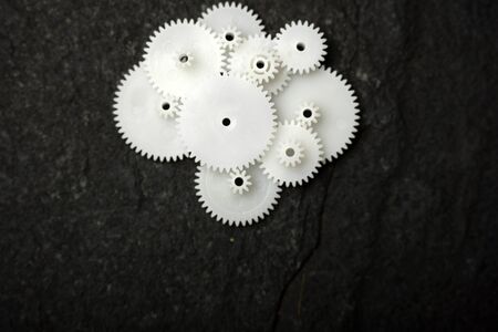 White wheel gears are on black texture backgroundの写真素材