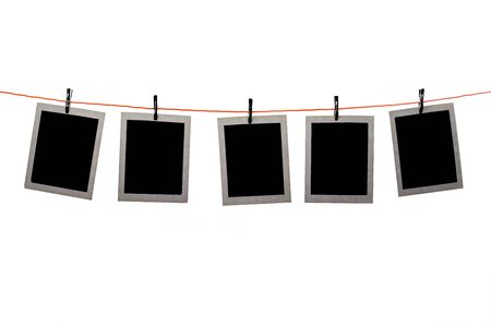 Blank pictures hanging in a line on white backgroundの写真素材