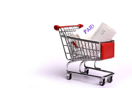 Shopping Receipts in shopping trolley isolated on white backgroundの写真素材