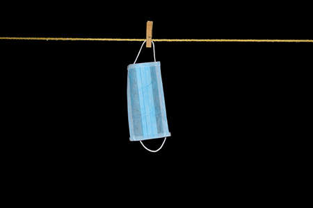 Facial mask hanging against black backgroundの写真素材