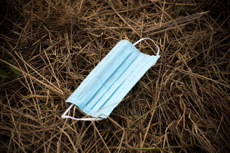 Medical face mask on the ground during the Covid-19 pandemic. The face masks used for the...