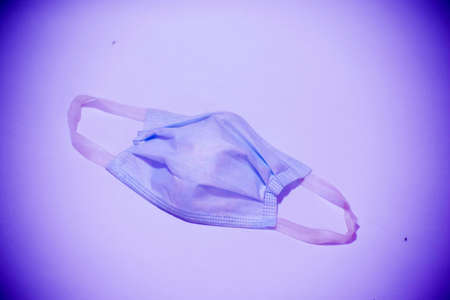 Close-up of facial mask isolated on blue backgroundの写真素材