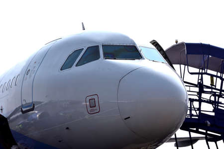 Front Close-up of a Large Commercial Jet Airplane against white background.
