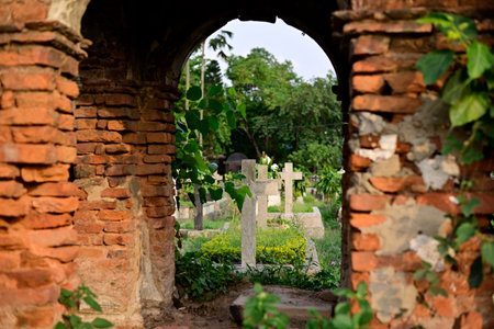 Jesus Cross is shown from old ruin brick building in cemeteryのeditorial素材