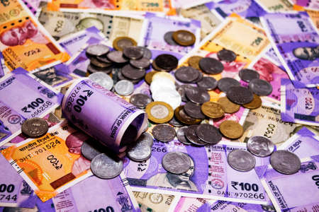 various Indian paper currency banknotes and coins as a background