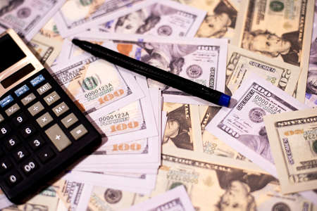 Counting US paper currency one hundred dollar in against us dollar backgroundの写真素材